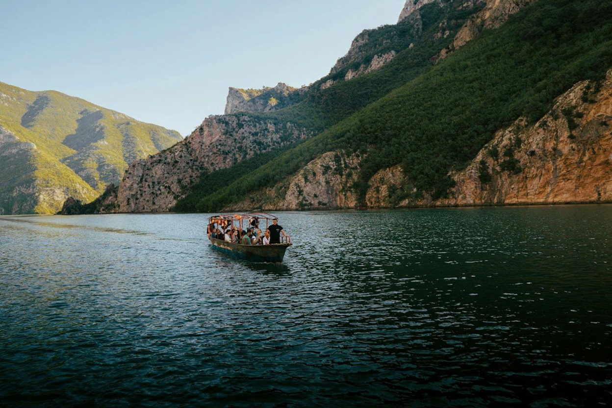 The Komani Lake ferry — three hours through a flooded canyon that looks like it was designed by someone who had never heard o
